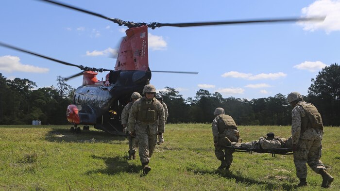 Navy corpsmen from 2nd Medical Battalion, along with supplemental Health Services Augmented Personnel, practice loading and unloading of simulated patients into the search and rescue aircraft during a field training exercise aboard Marine Corps Base Camp Lejeune, North Carolina, April 23, 2015. The purpose of the exercise was to train and prepare the HSAP’s for deployment to exercises African and Eager Lion.