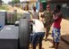 Maj. Robert C. Rogers, an Individual Mobilization Augmentee currently serving as the branch chief for the Air Force Civil Engineering Center’s Airfield Pavements Evaluation team, buys gasoline in glass jars from a local gas station in Liberia. (Courtesy photo/Master Sgt. James Dixon)