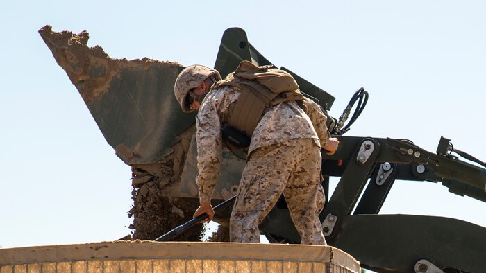 A Marine with 8th Engineer Support Battalion, 2nd Marine Logistics Group, fills hesco barriers with sand used as bunker walls during a week-long survivability exercise aboard Marine Corps Base Camp Lejeune, North Carolina, April 20-24, 2015. The Marines conducted the exercise to remain proficient in their military occupational specialty and to build camaraderie between the non-commissioned officers and the junior Marines of the battalion.