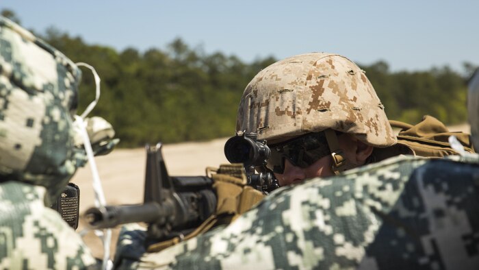 Pfc. John Fronbach, a combat engineer with 8th Engineer Support Battalion, 2nd Marine Logistics Group, and a Berlin, Maryland. native, posts security in a patrol base built by the unit during a week-long survivability exercise aboard Marine Corps Base Camp Lejeune, North Carolina, April 20-24, 2015. The Marines conducted the exercise to remain proficient in their military occupational specialty and to build camaraderie between the non-commissioned officers and the junior Marines of the battalion.