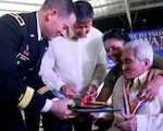 Oregon Army National Guard Brig. Gen. Steven R. Beach (right), Assistant Adjutant General for Support, and retired Lt. Gen. Ernesto G. Carolin, center, administrator, Philippines Veterans Affairs Office, present medals to Filipino WWII guerrilla fighters at the Provincial Capital on April 22, 2015. The awards are part of several events celebrating the 70-year anniversary of the end of WWII and the liberation of the island of Palawan, Philippines. The events, "A Salute to Valor: Palawan-70 years of freedom," honored the partnership of the Filipino guerrillas and the Oregon National Guard's 41st Infantry Division during WWII and their participation in the liberation in 1945. 