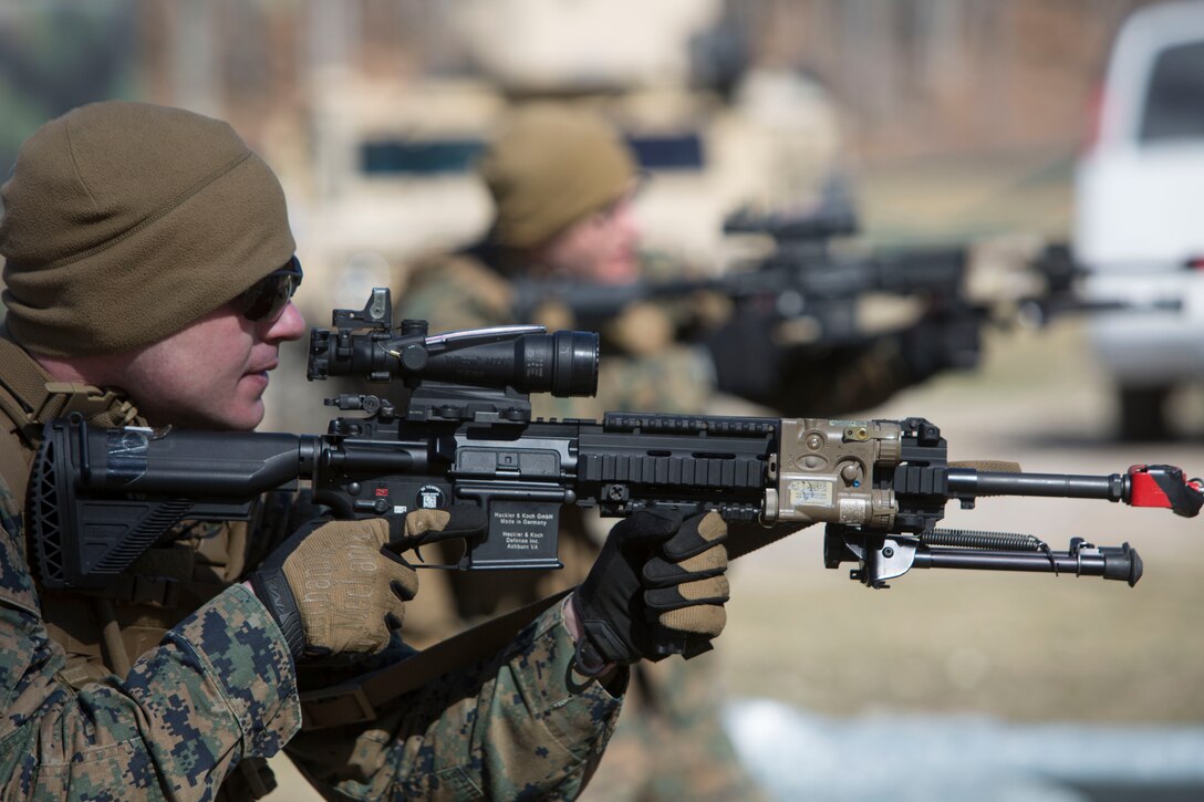 Lance Cpl. Grant R. Burch, a rifleman with Charlie Company, 1st Battalion, 24th Marine Regiment, 4th Marine Division, Marine Forces Reserve, simulates clearing a room during urban warfare training during Exercise Arctic Eagle at Camp Grayling, Mich., April 24, 2014. Marines joined members of the Army National Guard and the Danish Home Guard at the exercise to train counterinsurgency tactics and urban warfare. (U.S. Marine Corps photo by Cpl. Ian Leones/Released)