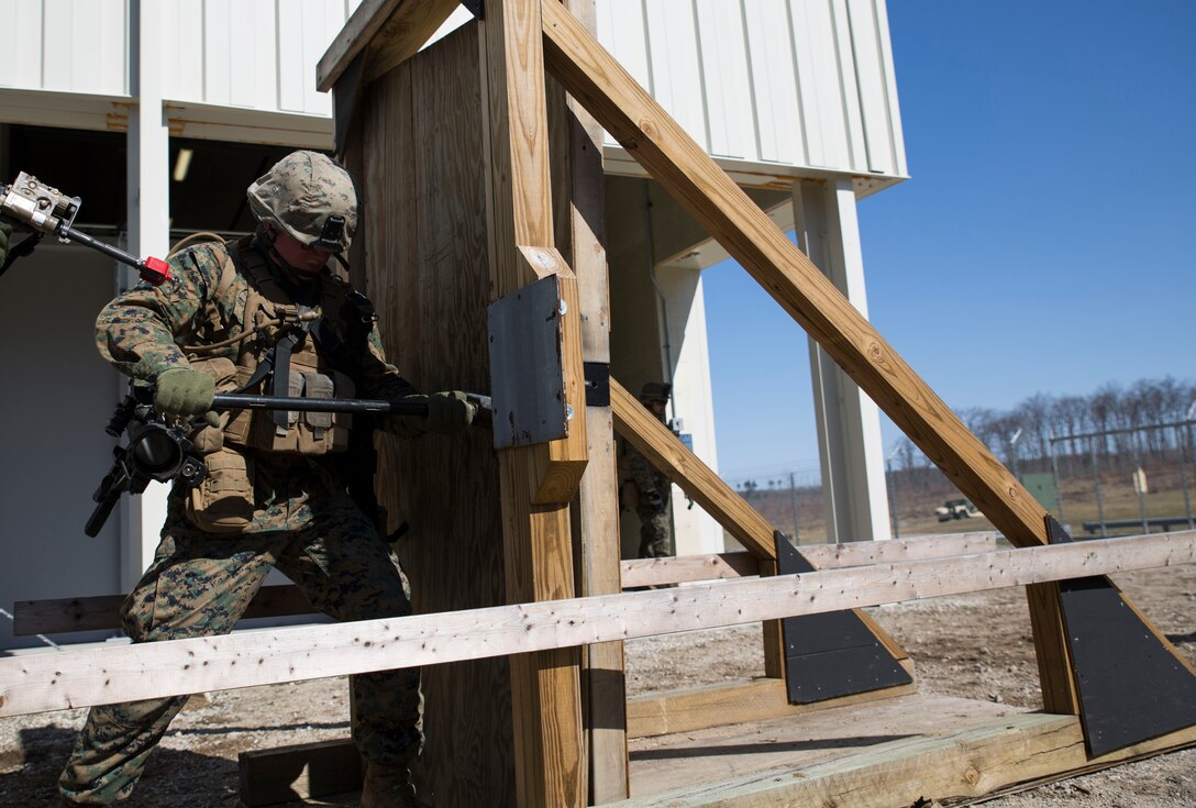 Pvt. Jesse J. Karker, an infantry assaultman with Charlie Company, 1st Battalion, 24th Marine Regiment, 4th Marine Division, Marine Forces Reserve, practices door breaching during Exercise Arctic Eagle at Camp Grayling, Mich., April 24, 2014. The Marines practiced tactics such as room clearing, door breaching, and urban patrolling as a work up to an urban warfare simulation at Camp Grayling's Combined Armed Collective Training Facility the following day. (U.S. Marine Corps photo by Cpl. Ian Leones/Released)