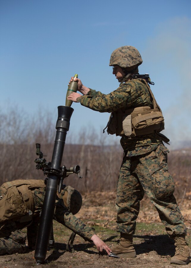 Cpl. Phillip M. Tuente (left) and Pvt. Alec M. Dugan (right), mortarmen with Weapons Company, 1st Battalion, 24th Marine Regiment, 4th Marine Division, Marine Forces Reserve, prepare to fire a M252 mortar during Exercise Arctic Eagle at Camp Grayling, Mich., April 24, 2015. A crew of five enlisted Marines operates and maintains each mortar on the firing line. (U.S. Marine Corps photo by Cpl. Ian Leones/Released)