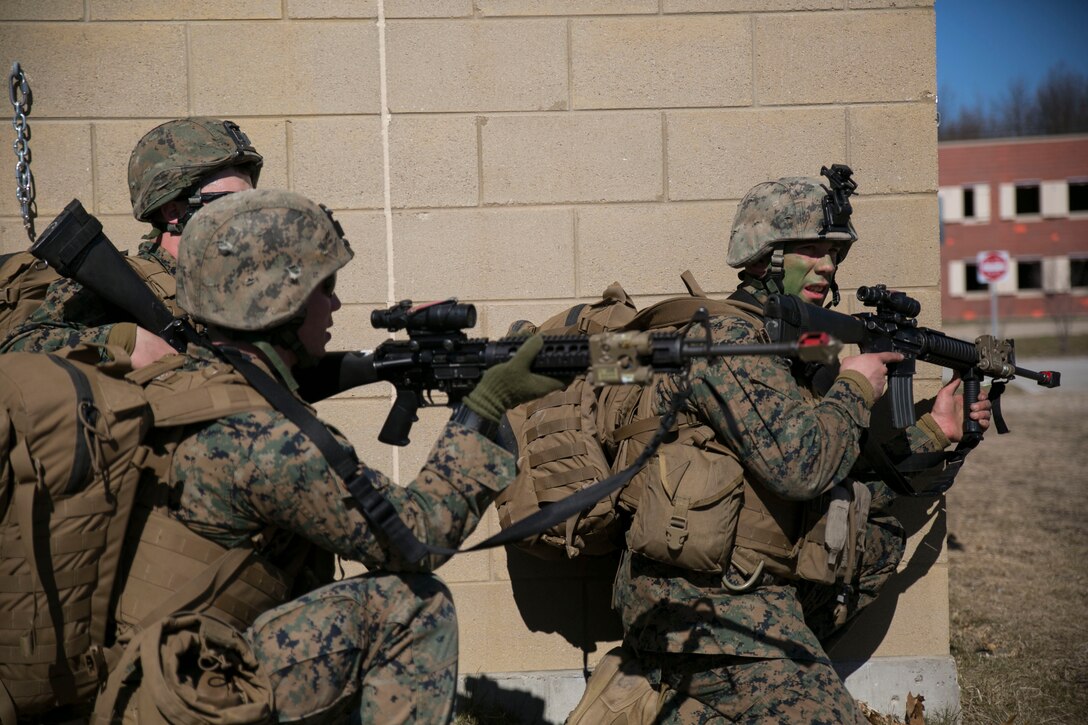 Marines with Charlie Company, 1st Battalion, 24th Marine Regiment, 4th Marine Division, Marine Forces Reserve, position themselves to clear a building with suspected enemy insurgents at Exercise Arctic Eagle at Camp Grayling, Mich., April 25, 2015. The Marines, with an attachment of soldiers from the Danish Home Guard, simulated retaking a city from enemy insurgents at Camp Grayling's Combined Arms Collective Training Facility. (U.S. Marine Corps photo by Cpl. Ian Leones/Released)