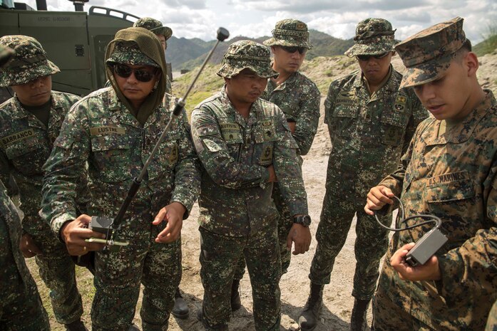 CROW VALLEY, Philippines (Apr. 23, 2015) - U.S. Marine Cpl. Erik Santos, a combat engineers assigned to Combat Logistic Battalion explains detonation triggers to Philippine Marine explosive ordnance disposal technicians assigned to Motor Transportation and Maintenance Battalion, Service Support Brigade during Exercise Balikatan 2015. The Marines both discussed and demonstrated the techniques and equipment they each use to do their job. Balikatan, which means "shoulder-to-shoulder" in Filipino, in an annual bilateral training exercise between U.S. and Philippine forces improving security cooperation activities, humanitarian assistance and disaster relief capabilities, and crisis response throughout the region. 