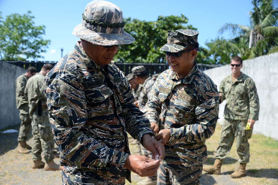 Philippine sailors, assigned to Navy Special Operations Group Explosive Ordnance Disposal Unit, conduct training on explosive door breaching with U.S. Navy sailors, assigned to Explosive Ordnance Disposal Mobile Unit 5, during Balikatan 2015 aboard Naval Base Cavite, Philippines, April 23. Balikatan, which means "shoulder to shoulder" in Filipino, is an annual bilateral training exercise aimed at improving the ability of Philippine and U.S. military forces to work together during planning, contingency, humanitarian assistance and disaster relief operations.