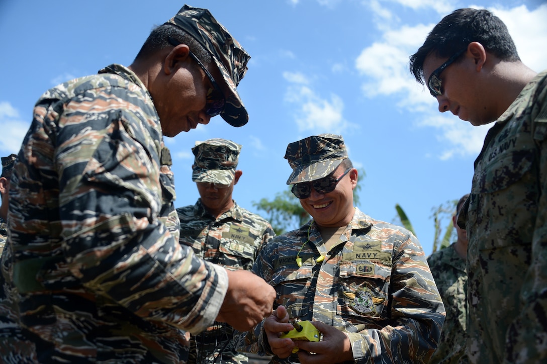 Philippine sailors, assigned to Navy Special Operations Group Explosive Ordnance Disposal Unit, conduct training on explosive door breaching with U.S. Navy sailors, assigned to Explosive Ordnance Disposal Mobile Unit 5, during Balikatan 2015 aboard Naval Base Cavite, Philippines, April 23. Balikatan, which means "shoulder to shoulder" in Filipino, is an annual bilateral training exercise aimed at improving the ability of Philippine and U.S. military forces to work together during planning, contingency, humanitarian assistance and disaster relief operations.