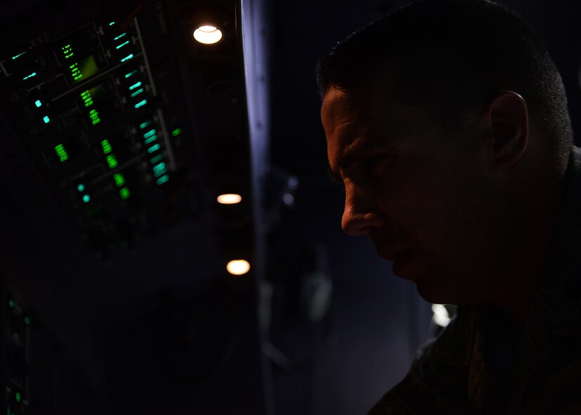 U.S. Air Force Maj. Kevin Bishop, 27th Special Operations Wing Inspector General deputy, oversees the progress of selected 27th Special Operations Wing Staff Agency Air Commandos who were given the opportunity to tour the flight simulators April 21, 2015 at Cannon Air Force Base, N.M. Bishop provided the Airmen the essentials required to maneuver the aircraft before letting them take control of the simulator. (U.S. Air Force photo/Airman 1st Class Chip Slack)