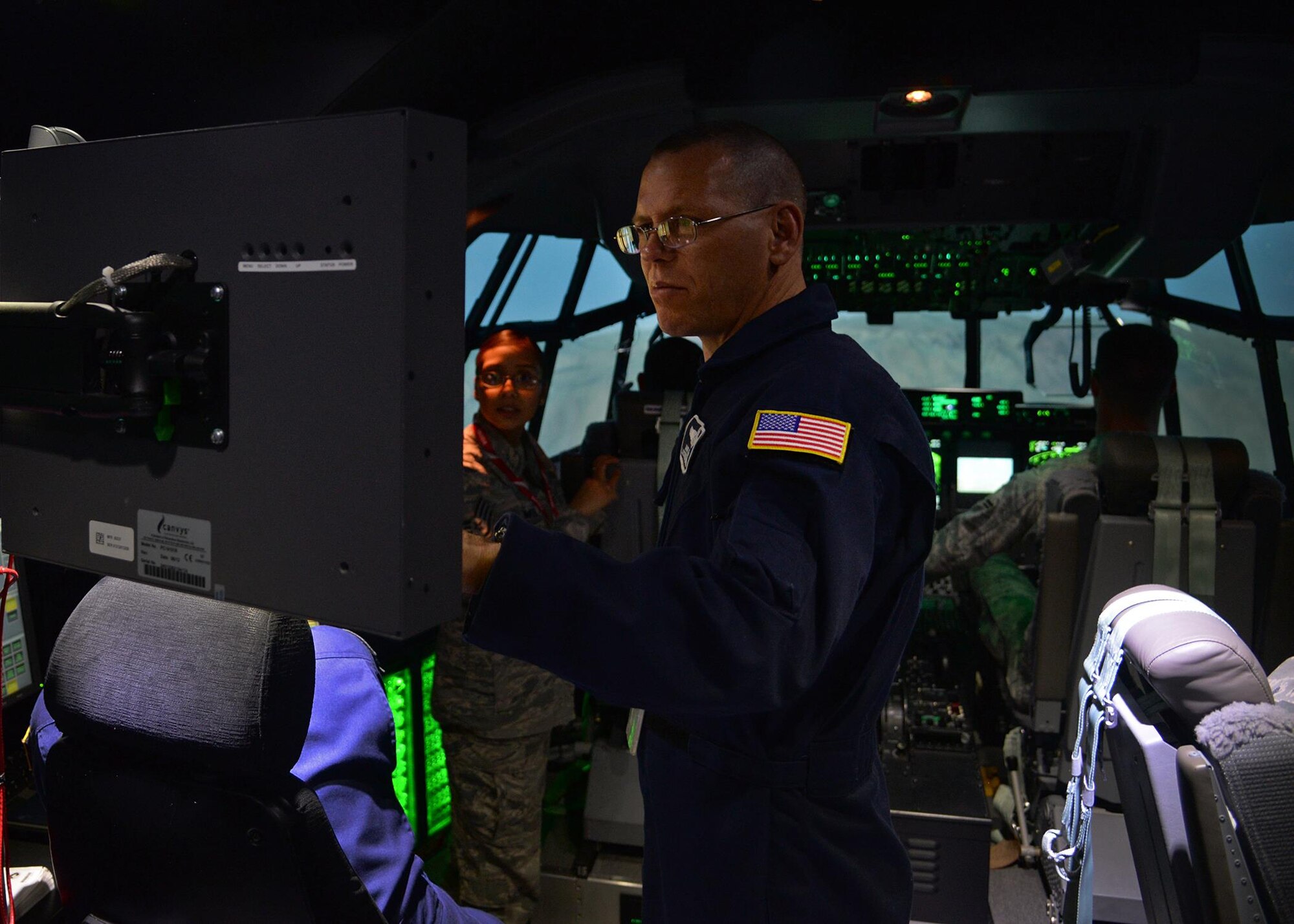 Mike Boyles, 551st Special Operations Squadron and Lockheed Martin flight instructor, monitors a simulated refueling mission during a tour of the MC-130 J Commando II flight simulator April 21, 2015 at Cannon Air Force Base, N.M. Airmen from the 27th Special Operations Wing Staff Agency had the opportunity to pilot the MC-130 J simulator in an effort to give airmen who would not normally have the opportunity to get hands-on experience with the simulators or who have career fields that limit access to Cannon’s aircraft, an inside look as to what is required of Cannon’s pilots. (U.S. Air Force photo/Airman 1st Class Chip Slack)