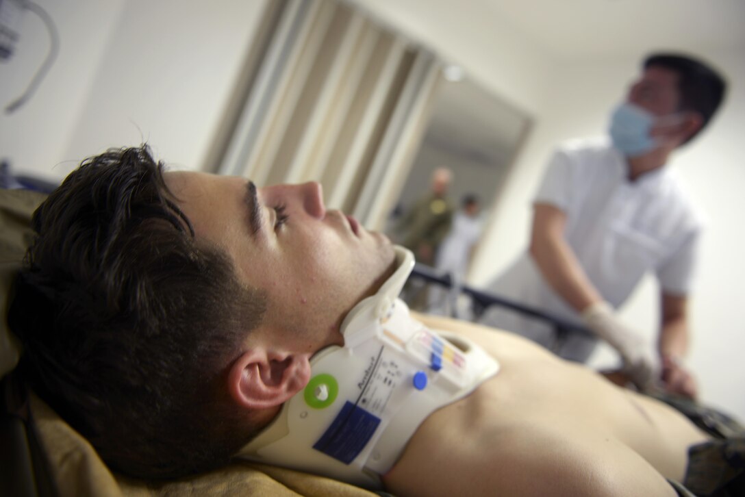 Dante Pineda, an emergency room nurse from Medical City Clark, Philippines, checks the vital signs of a simulated patient, during a medical evacuation scenario as part of Exercise Balikatan 2015, April 18, 2015. Exercise Balikatan is a regularly conducted exercise focused on scenario-based combined action planning in territorial defense, disaster relief, civic assistance and tactical level field training.