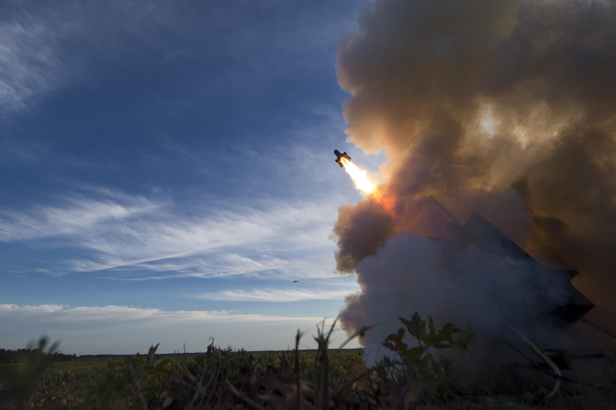 A training rocket launches to engage incoming aircraft during Emerald Warrior 2015, at Elizabeth Drop Zone, Fla., April 22, 2015. The 1st Special Operations Support Squadron directs operations of nine unique flights with more than 400 personnel in the most diverse operations support squadron in the Air Force. Emerald Warrior is the Department of Defense's only irregular warfare exercise, allowing joint and combined partners to train together and prepare for real-world contingency operations. (U.S. Air Force photo by Staff Sgt. DeAndre Curtiss/Released)
