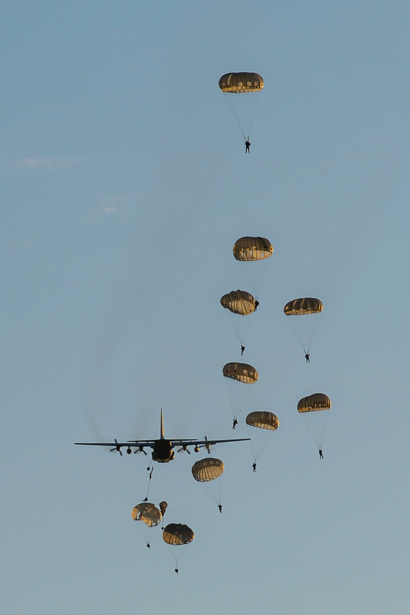 U.S. Army Soldiers with the 7th Special Forces Group perform static-line parachute jumps out of a C-130H3 Hercules during Emerald Warrior 2015 at Eglin Air Force Base, Fla., April 21, 2015. Emerald Warrior is the Department of Defense's only irregular warfare exercise, allowing joint and combined partners to train together and prepare for real-world contingency operations. (U.S. Air Force photo by Staff Sgt. Jamal D. Sutter/Released)
