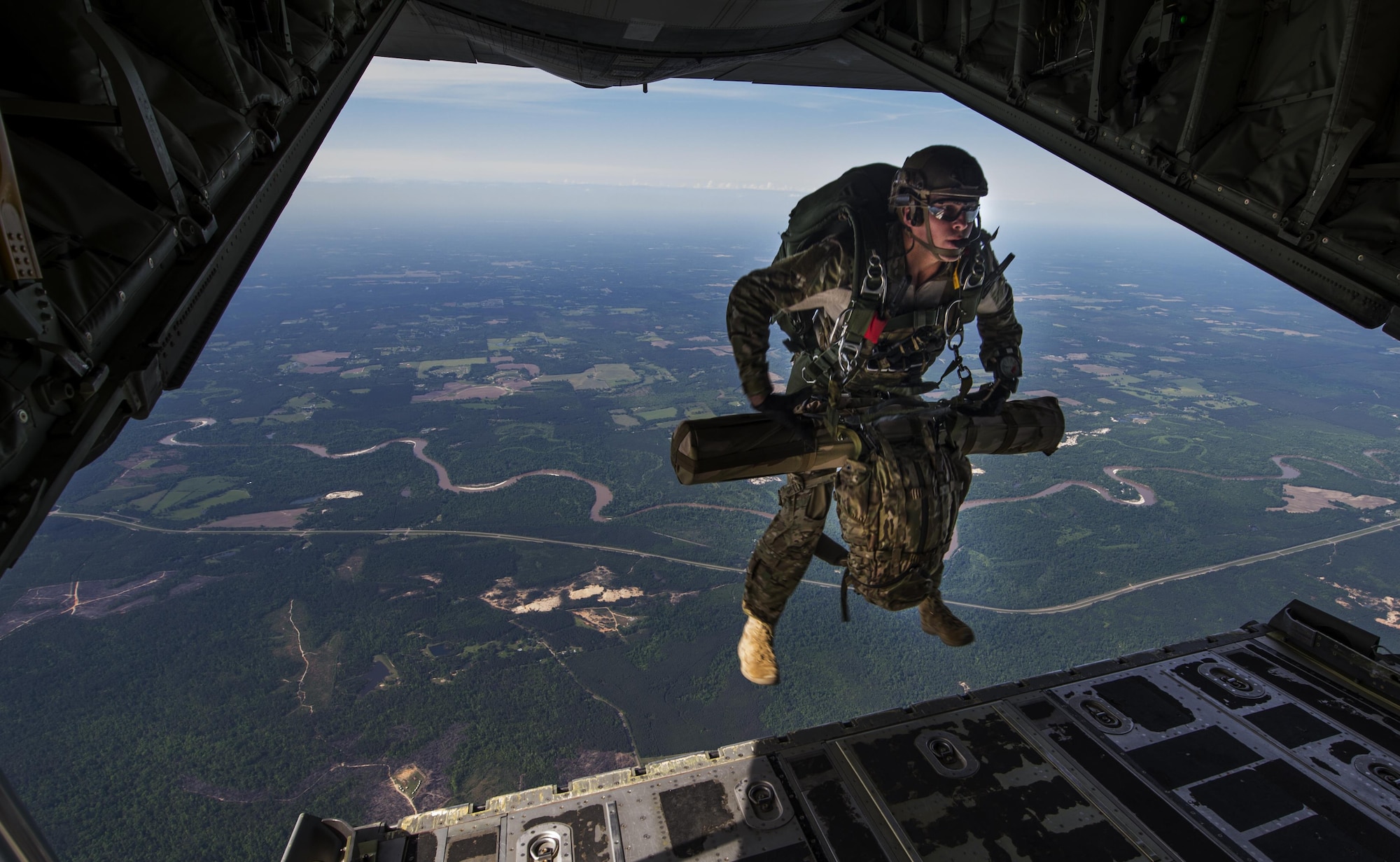 A U.S. Air Force combat controller jumps out of an MC-130J Combat Shadow II during Emerald Warrior 2015 at Hurlburt Field, Fla., April 22, 2015. Emerald Warrior is the Department of Defense's only irregular warfare exercise, allowing joint and combined partners to train together and prepare for real-world contingency operations. (U.S. Air Force photo by Staff Sgt. Douglas Ellis/Released)