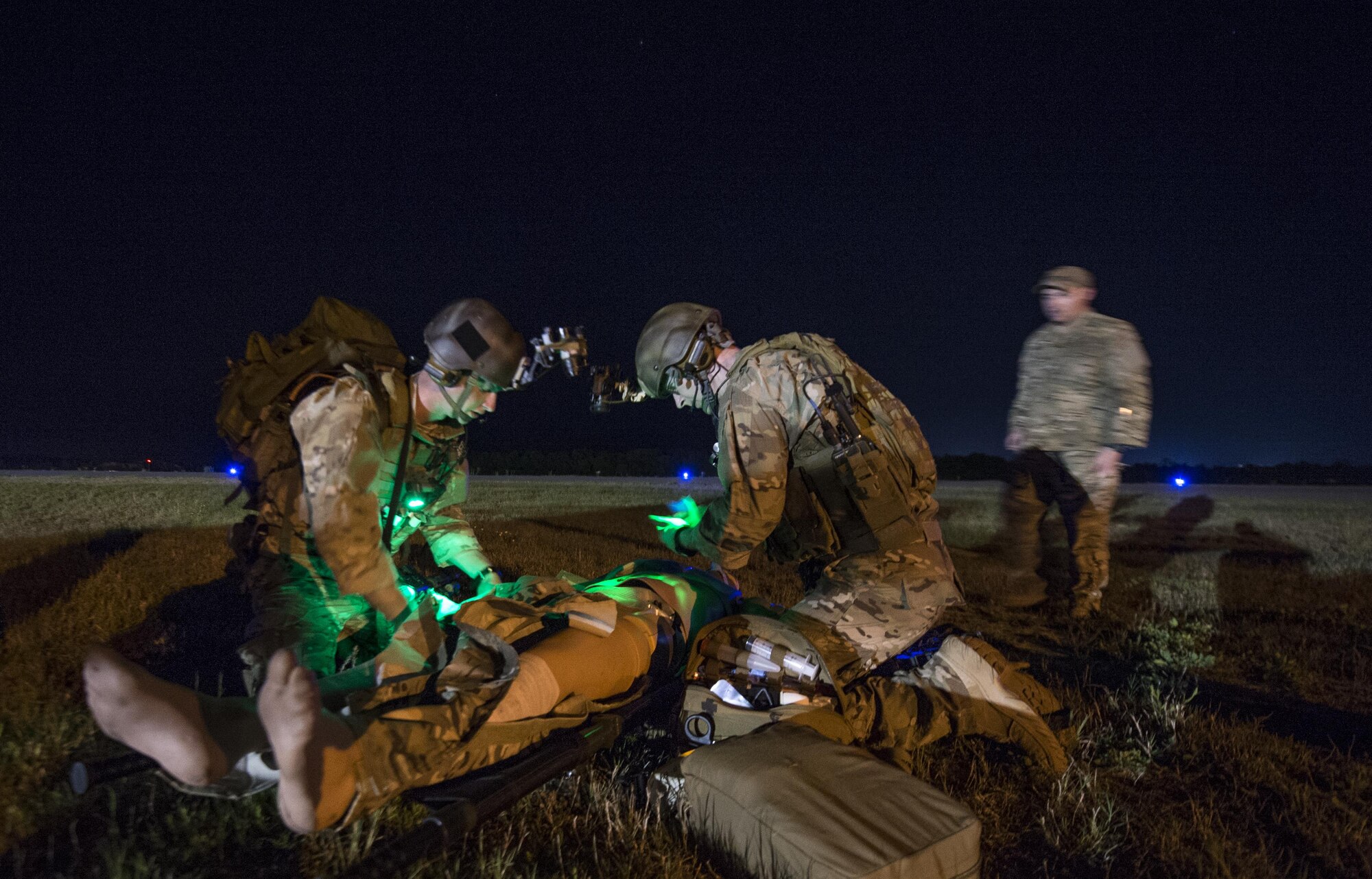 A U.S. Air Force special operations forces medical element team member, 1st Special Operations Support Squadron, and a U.S. Army Special Operations Resuscitation Team member, 528th Sustainment Brigade, examine a patient on Crestview Airfield, Fla., April 23, 2015. Emerald Warrior is the Department of Defense's only irregular warfare exercise, allowing joint and combined partners to train together and prepare for real world contingency operations. (U.S. Air Force photo by Senior Airman Cory D. Payne/Released)