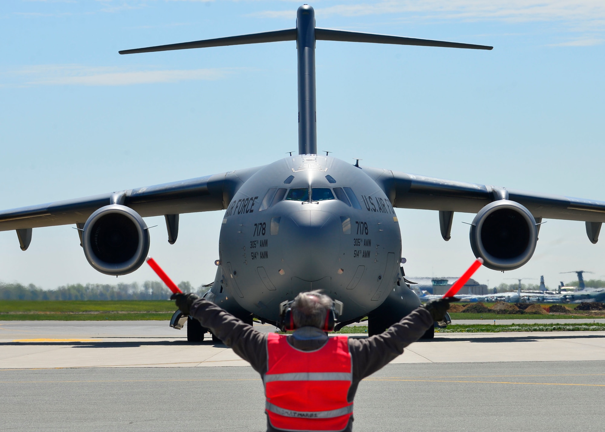 Bill Kennedy marshals a C-17 Globemaster III at Dover Air Force Base, Del., April 26, 2015. The aircraft was loaded with 69 members of the Fairfax County Urban Search and Rescue Team, their supplies and equipment, and six K-9s, to assist Nepal with rescue operations after the country was struck by a 7.8-magnitude earthquake. Kennedy is assigned to the 436th Aircraft Maintenance Squadron transit alert section. (U.S. Air Force photo/Airman 1st Class William Johnson)