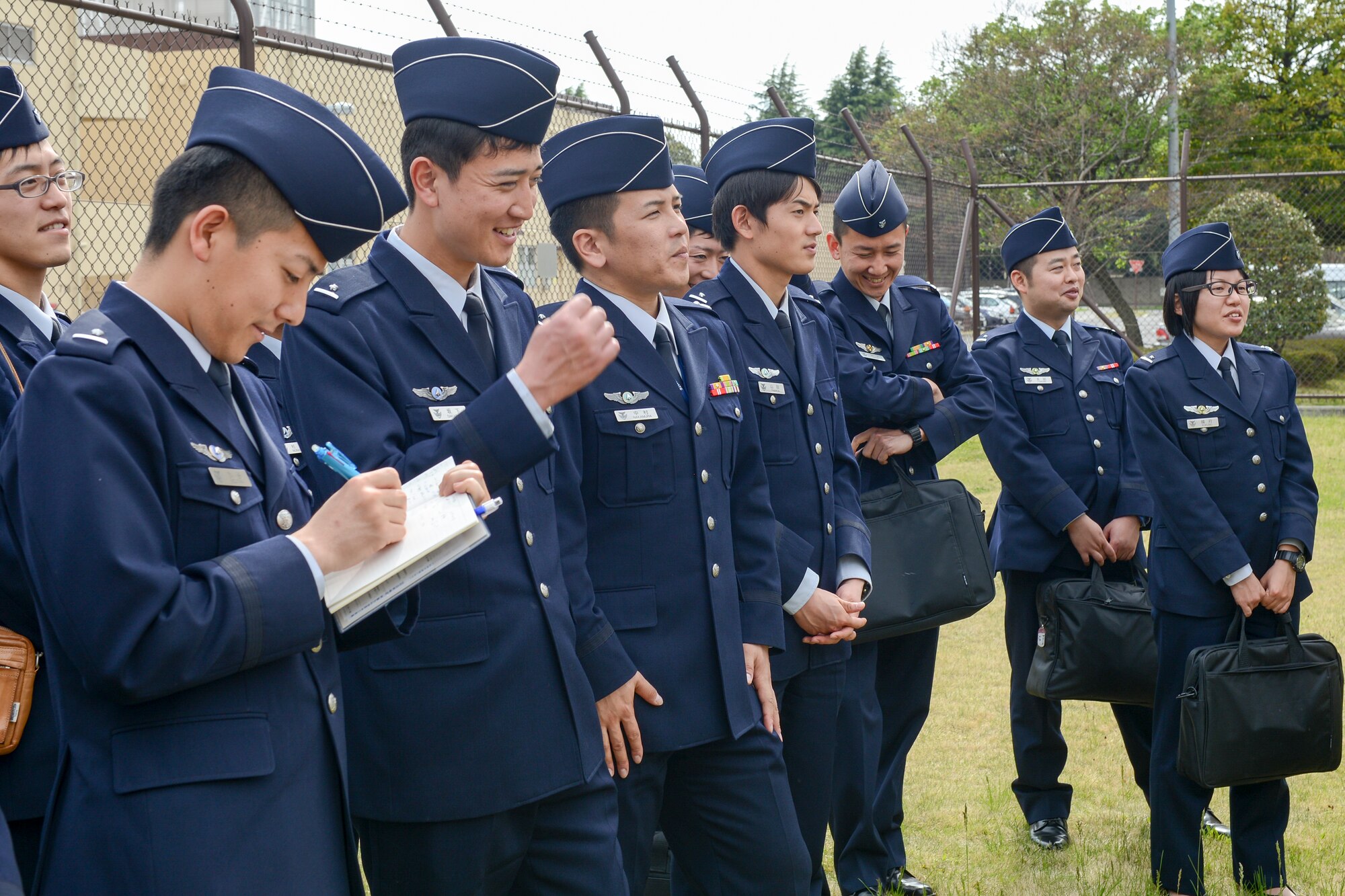 Japan Air Self-Defense Force communications officer students take notes during the site visit at Yokota Air Base, Japan, April 24, 2015.  The JASDF students are from the 4th Technical School, Kumagaya Air Base. (U.S. Air Force photo by Senior Airman Desiree Economides/Released)
