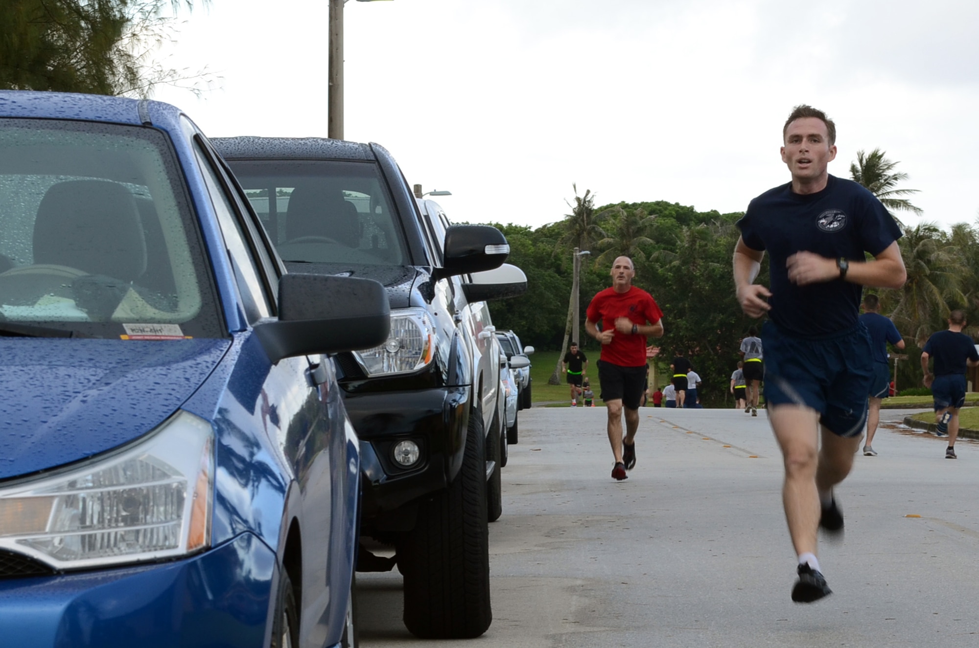 Steven Brumley, 36th Communications Squadron, sprints to the finish line of the Sexual Assault Awareness Month 5K at Andersen Air Force Base, Guam, April 27, 2015. Brumley came in first place with a time of 19:09. The 5K brought the sister services together to bring awareness to sexual assault prevention. (U.S. Air Force photo by Airman 1st Class Alexa Ann Henderson/Released)