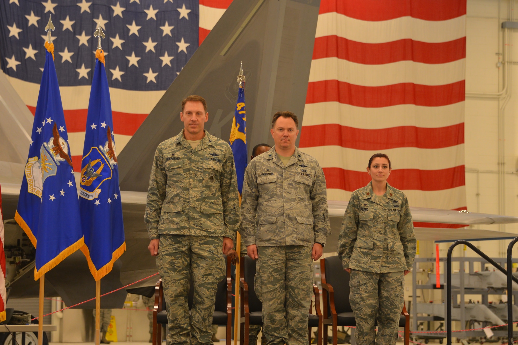 Col. David Piffarerio, 477th Fighter Group Commander, Lt. Col. Timothy Pemberton and Maj. Jessica Pisano stand at the position of attention during the signing of the nation anthem during a change of command ceremony held here April 12, 2015.(US Air Force photo/Tech. Sgt. Dana Rosso)