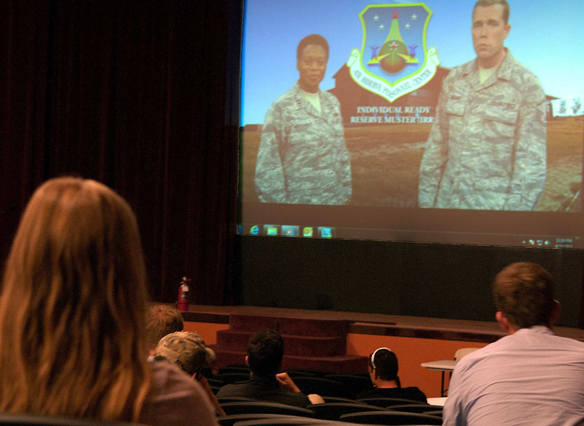 Members of the individual ready reserve watch a video briefing during an IRR muster April 23, 2015 in the F.E. Warren Air Force Base, Wyo., theater. The muster allowed IRR personnel to ensure the military had the correct contact and medical information on file incase of a Presidential Reserve Call-up. (U.S. Air Force photo by Airman 1st Class Brandon Valle)
