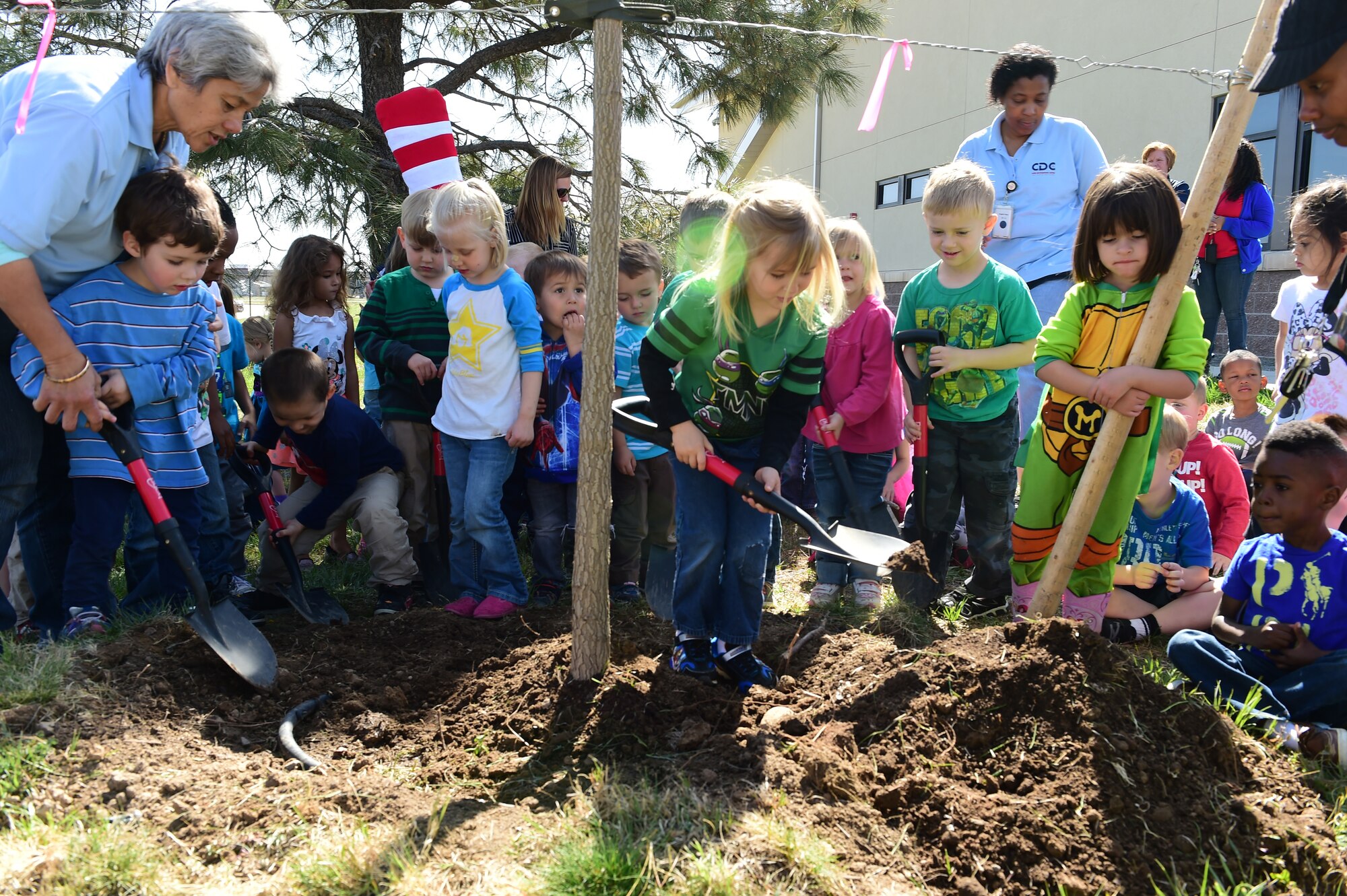 Children from the Crested Butte Child Development Center participate in a ceremonially planting of a tree to symbolize Buckley Air Force Base achieving Tree City USA status April 23 at Buckley AFB, Colo. Buckley received the Tree City USA award for meeting four core standards of sound urban forestry management: maintaining a tree board or department, having a community tree ordinance, spending at least $2 per capita on urban forestry and celebrating Arbor Day. “It is our opportunity to show the community that we care for their community, as our operations affect their environment,” said Celiann Gonzalez Jurabe, 460th Civil Engineer Squadron environmental element chief. (Air Force photo by Airman 1st Class Luke W. Nowakowski/Released)