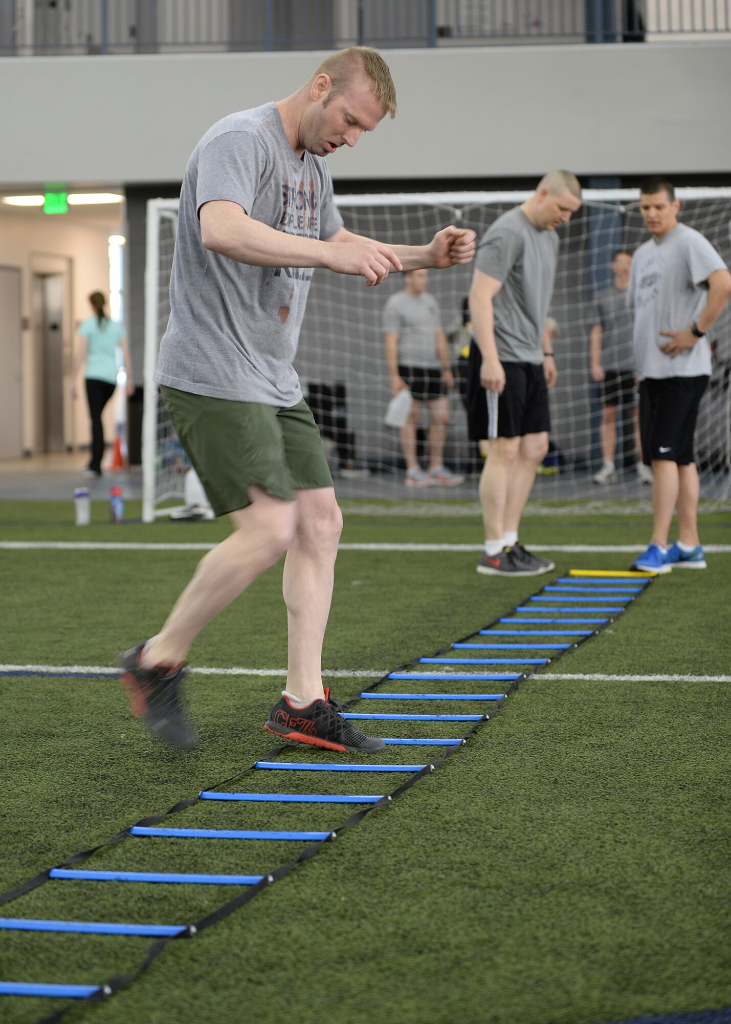 U.S. Air Force Master Sgt. Christopher Bounds, the 354th Security Forces Squadron first sergeant, rushes through the agility ladder during the “Tough Enough” competition April 24, 2015, at the Baker Field House on Eielson Air Force Base, Alaska. The “Tough Enough” competition was a series of strength-based exercises to promote sexual assault awareness and prevention while introducing knowledge on the subject. (U.S. Air Force photo by Staff Sgt. Shawn Nickel/Released)