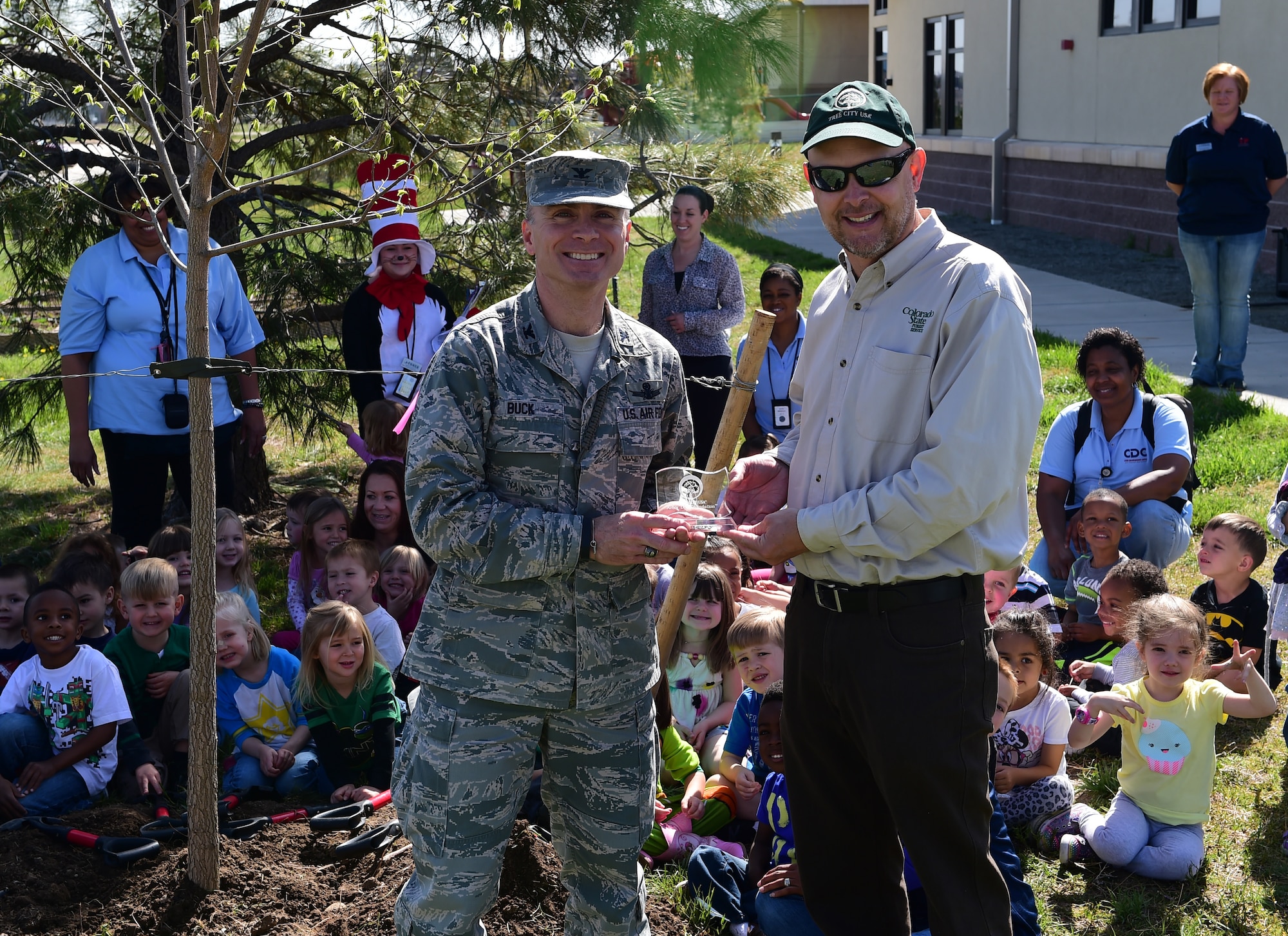 Col. Darren Buck, 460th Space Wing vice commander, was presented the Tree City USA award from Keith Wood, Colorado State Forester and member of the Arbor Day Foundation April 23 on Buckley AFB, Colo. Communities achieve Tree City USA status by meeting four core standards of sound urban forestry management: maintaining a tree board or department, having a community tree ordinance, spending at least $2 per capita on urban forestry and celebrating Arbor Day. Trees in Buckley increase property values, enhance the economic vitality of business areas and beautify our community. (Air Force photo by Airman 1st Class Luke W. Nowakowski/Released)
