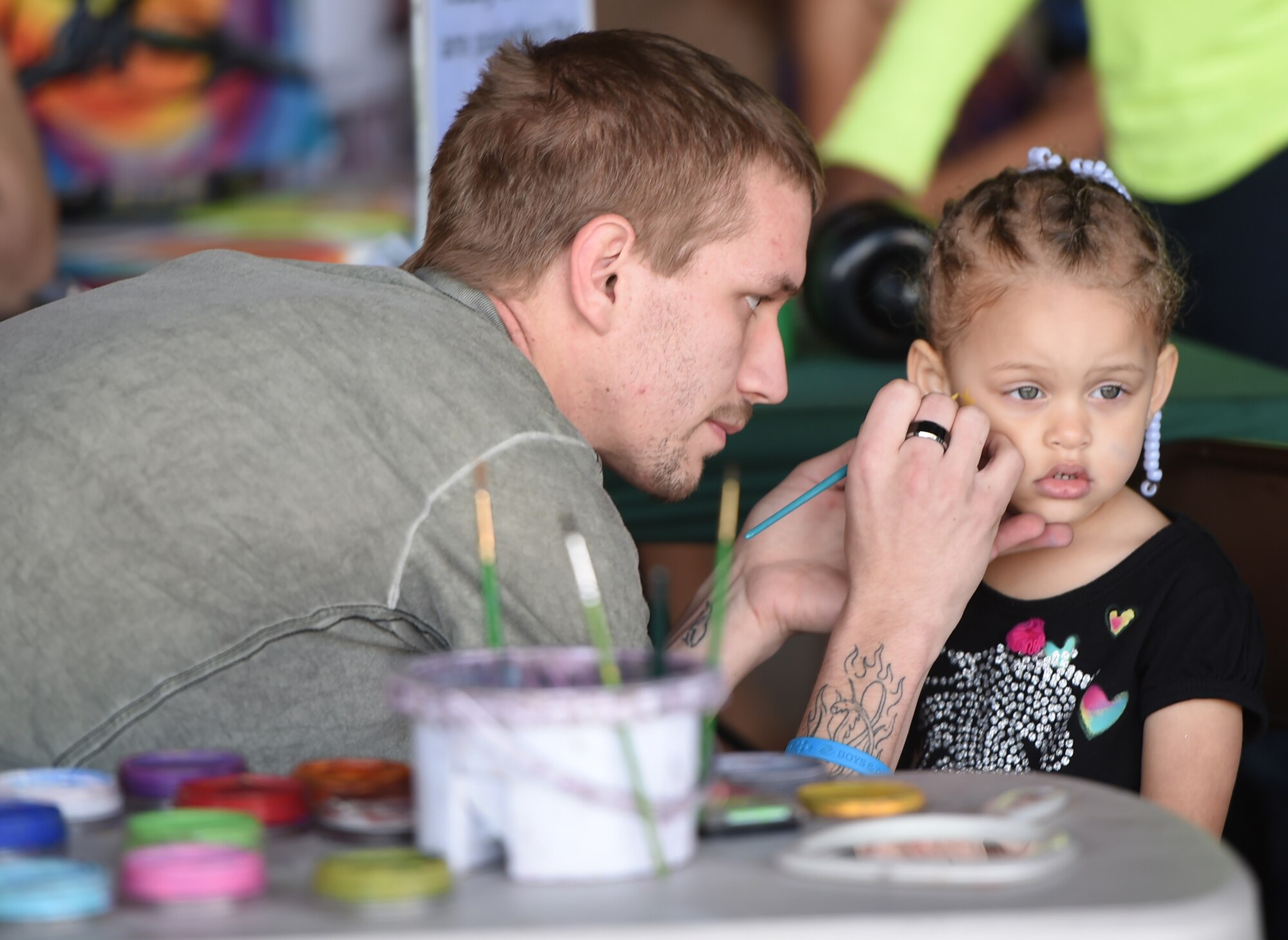 Keimora, three, daughter of Tech. Sgt. Nicholas, 18th Reconnaissance Squadron sensor operator, gets her face painted during a “Take Your Kid to Work Day” event April 23, 2015 at Creech Air Force Base, Nevada.  During the day's events the Creech Airmen and various base and local organizations provided a plethora of events including demonstrations from the local fire department, work center tours, a professional magician, and a DJ. (U.S. Air Force photo by Tech Sgt. Nadine Barclay/Released)