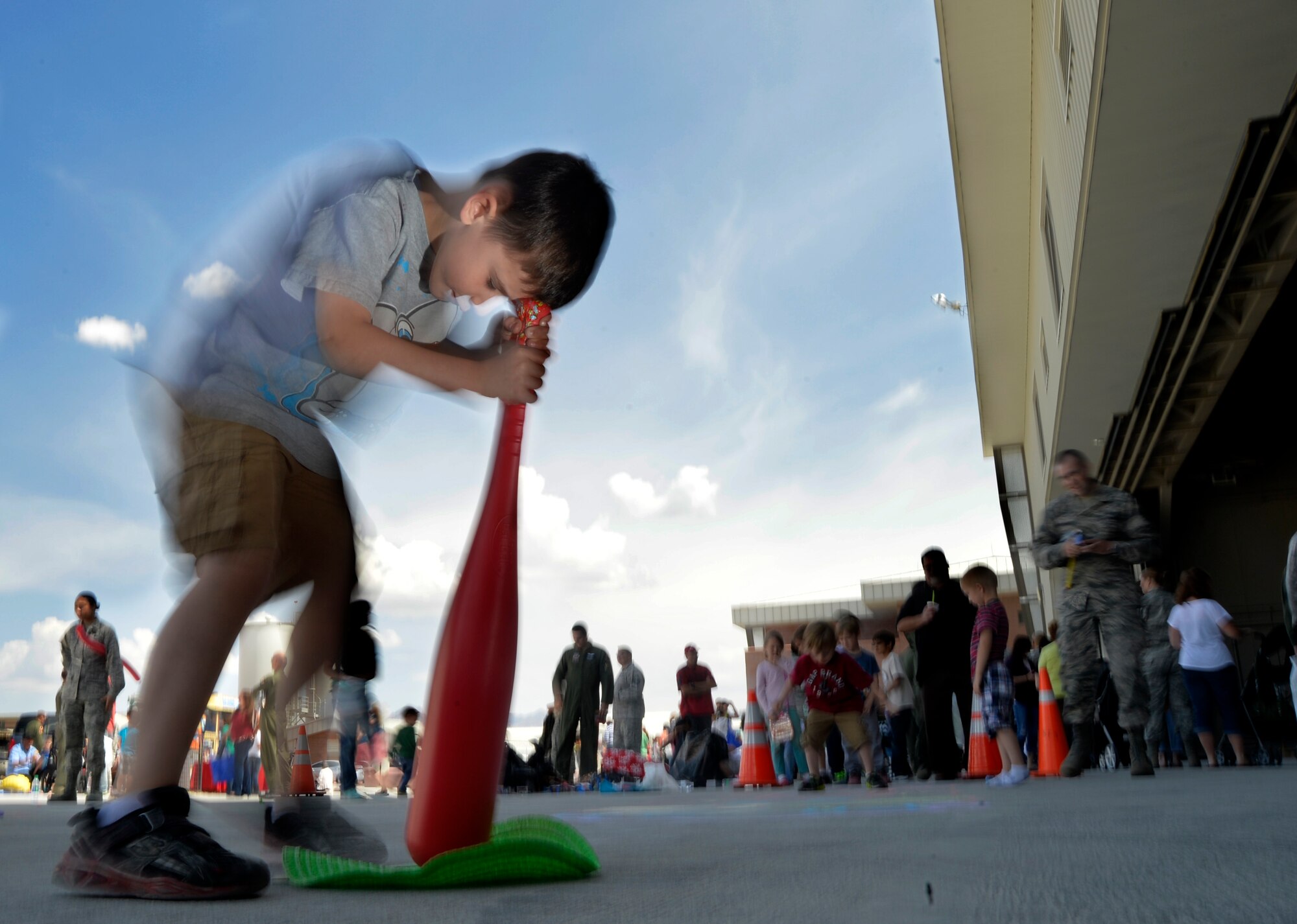 Gabriel, seven, son of Capt. Amanda, 78th Attack Squadron intelligence officer, spins around a baseball bat April 23, 2015, at Creech Air Force Base, Nevada. As part of the Department of Defense observance of Month of the Military Child, Creech Airmen paid tribute to these small tykes by honoring them with a “Take Your Kid to Work Day” event. (U.S. Air Force photo by Airman 1st Class Christian Clausen/Released)