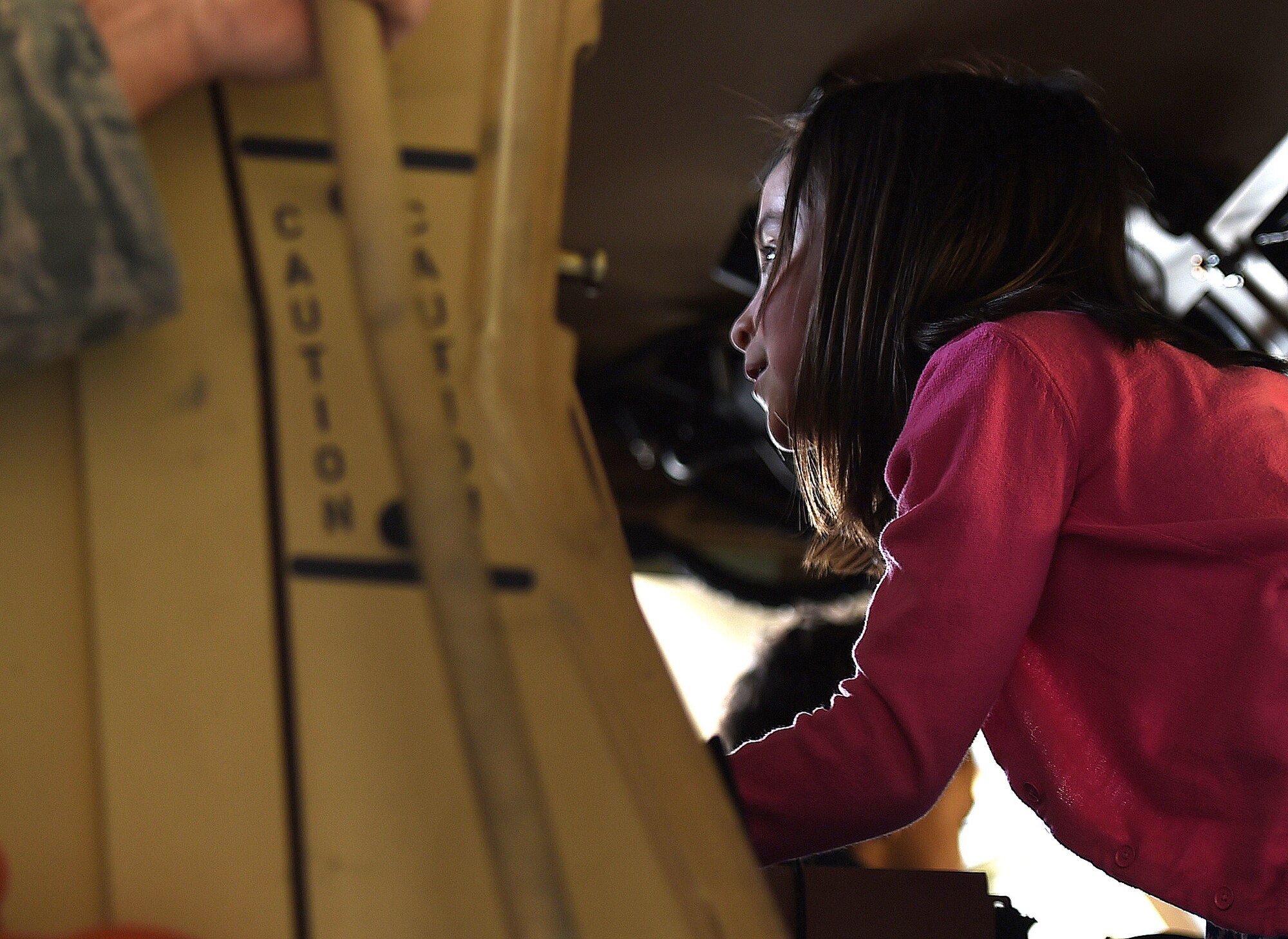 Avah, eight, daughter of Staff Sgt. Michael Barclay, 757th Aircraft Maintenance Squadron A-10 Thunderbolt II crew chief, climbs through a security forces mine-resistant ambush protected vehicle, or MRAP, on display during the “Take Your Kid to Work Day” event April 23, 2015, Creech Air Force Base, Nevada.  Creech families honored the Month of the Military Child with food, face painting, and a magic show sponsored by the Las Vegas USO. In addition military vehicles and equipment were also on display and included the MQ-1 Predator and MQ-9 Reaper aircraft. (U.S. Air Force photo by Tech Sgt. Nadine Barclay/Released)