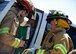 Tech. Sgt. Laurence Holter, 28th Comptroller Squadron NCO in charge of finance services, simulates a head injury caused by a vehicle accident during a major accident response exercise at Ellsworth Air Force Base, S.D., April 22, 2015. The MARE was designed to prepare and assess base personnel and responders actions during severe weather conditions. (U.S. Air Force photo by Senior Airman Anania Tekurio/Released)