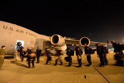 Members of the Urban Search and Rescue Task Force 2 board a C-17 Globemaster III from Joint Base Charleston, S.C., at March Air Reserve Base, Calif., April 26, 2015. In all, 57 members of CA-TF2, along with their equipment and six search dogs will travel to Nepal to assist in the earthquake relief efforts. When called upon, these teams travel with specialized equipment, such as heavy concrete cutting equipment, chainsaws, search cameras and sonar to locate victims, as well as specialized communications and generators. To keep the aircraft moving, the mission will be flown by three different aircrews, two from the 437th Airlift Wing at JB Charleston and one from the 164th Airlift Wing at the Tennessee Air National Guard in Memphis, TN.  (U.S. Air Force photo by Airman 1st Class Taylor Queen/Released) 