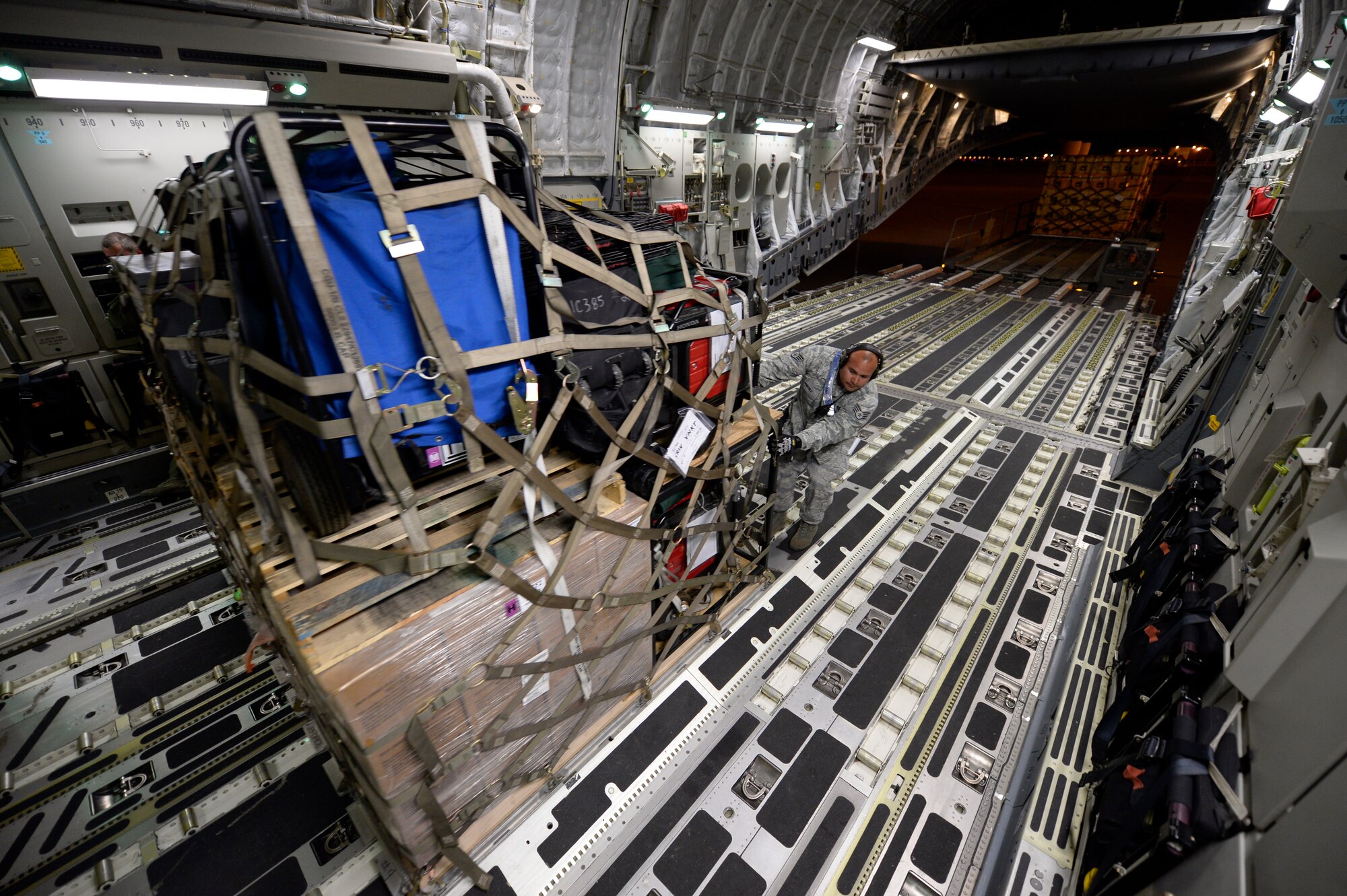 U.S. Air Force personnel load relief supplies for victims of the Nepal earthquake into a USAF C-17 Globemaster III from Joint Base Charleston, S.C., at March Air Force Base, Calif., April 26, 2015. The U.S. Agency of International Development relief cargo included eight pallets, 59 Los Angeles County Fire Department personnel and five search and rescue dogs. (U.S. Air Force photo by Airman 1st Class Taylor Queen/Released)