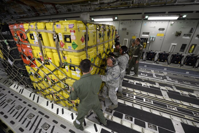 U.S. Air Force personnel load relief supplies for victims of the Nepal earthquake into a USAF C-17 Globemaster III from Joint Base Charleston, S.C., at March Air Force Base, Calif., April 26, 2015. The U.S. Agency of International Development relief cargo included eight pallets, 59 Los Angeles County Fire Department personnel and five search and rescue dogs. (U.S. Air Force photo by Airman 1st Class Taylor Queen/Released)