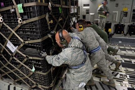 U.S. Air Force personnel load relief supplies for victims of the Nepal earthquake into a USAF C-17 Globemaster III from Joint Base Charleston, S.C., at March Air Force Base, Calif., April 26, 2015. The U.S. Agency of International Development relief cargo included eight pallets, 59 Los Angeles County Fire Department personnel and five search and rescue dogs. (U.S. Air Force photo by Airman 1st Class Taylor Queen/Released)