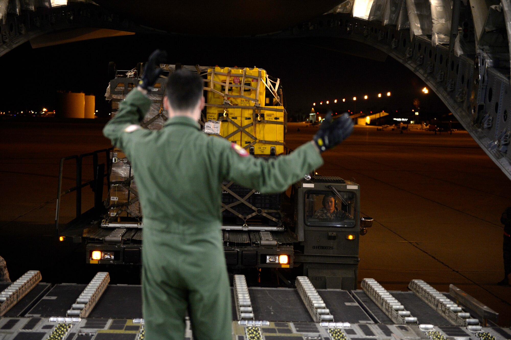 U.S. Air Force personnel load relief supplies for victims of the Nepal earthquake into a USAF C-17 Globemaster III from Joint Base Charleston, S.C., at March Air Force Base, Calif., April 26, 2015. The U.S. Agency of International Development relief cargo included eight pallets, 59 Los Angeles County Fire Department personnel and five search and rescue dogs. (U.S. Air Force photo by Airman 1st Class Taylor Queen/Released)