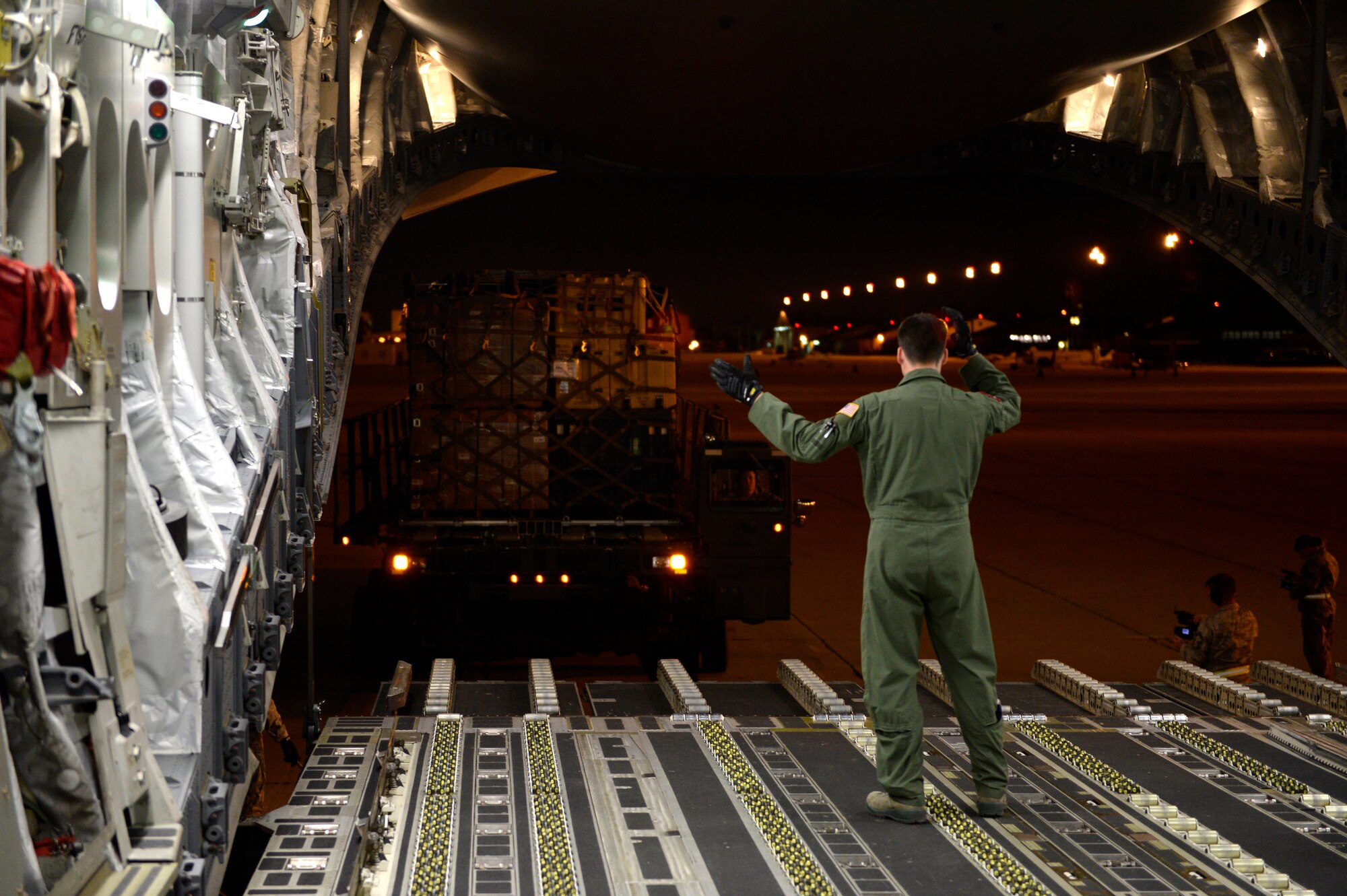 U.S. Air Force personnel load relief supplies for victims of the Nepal earthquake into a USAF C-17 Globemaster III from Joint Base Charleston, S.C., at March Air Force Base, Calif., April 26, 2015. The U.S. Agency of International Development relief cargo included eight pallets, 59 Los Angeles County Fire Department personnel and five search and rescue dogs. (U.S. Air Force photo by Airman 1st Class Taylor Queen/Released)