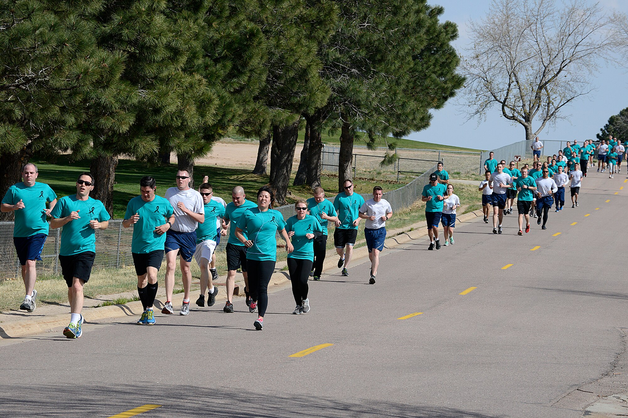 PETERSON AIR FORCE BASE, Colo. – A group of runners take part in the Sexual Assault Awareness and Prevention Month run April 21. Other events included a traveling memorial display including 234 flags representing the number of sexual assault victims on Team Pete within the last six years, life-size silent witnesses with survivors' stories on getting through sexual assault and an essay contest on how to make a difference and prevent sexual assault. (U.S. Air Force photo by Rob Bussard)