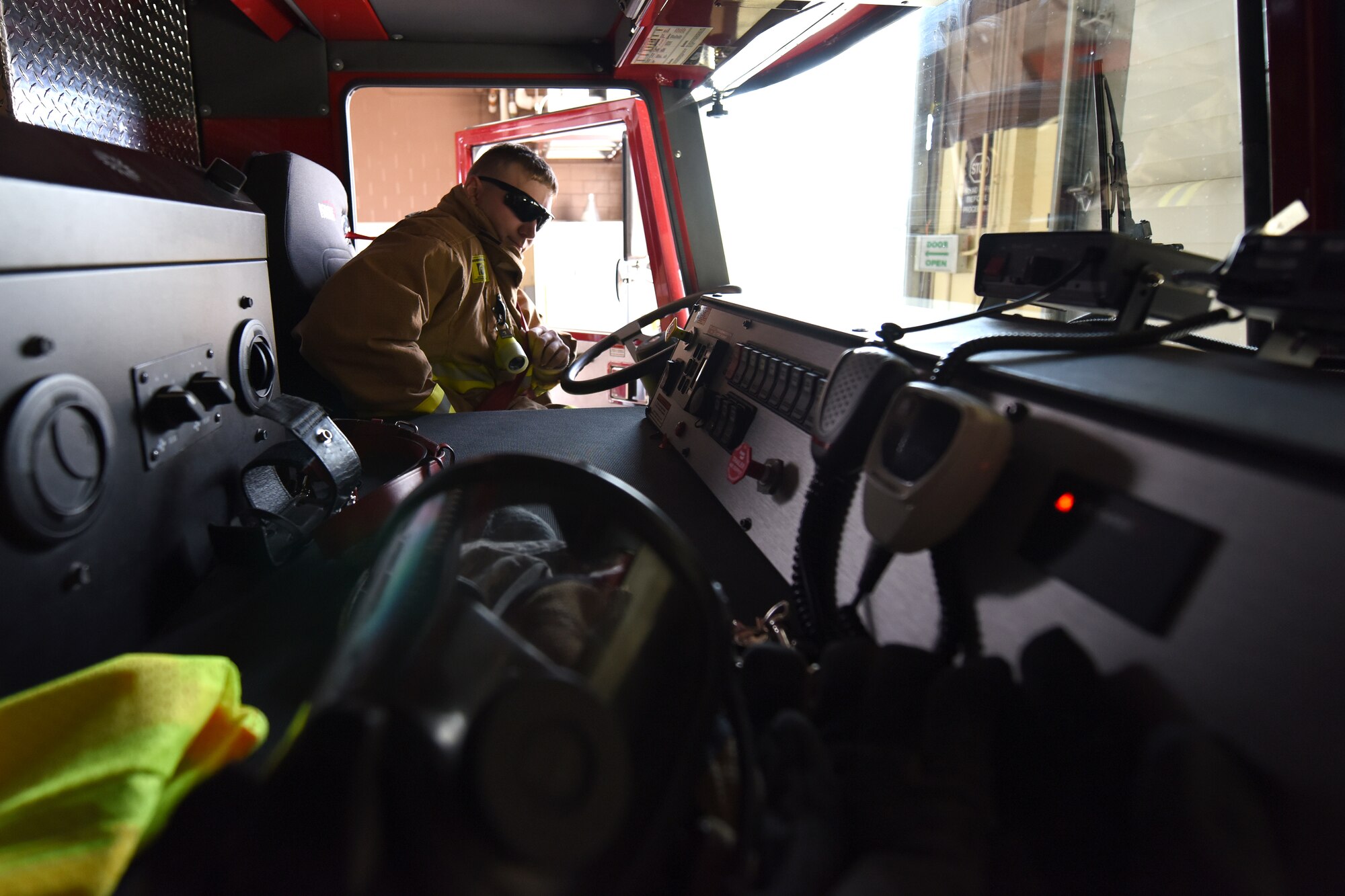 Senior Airman James Weaver, 341st Civil Engineer Squadron fire protection driver, applies his seat belt in preparation to drive a pumper truck to a practice emergency scene April 23, 2015, at Malmstrom Air Force Base, Mont. The Malmstrom Fire Emergency Services Flight provides an all-hazards emergency response capability, along with command and control for the base. (U.S. Air Force photo/Chris Willis)