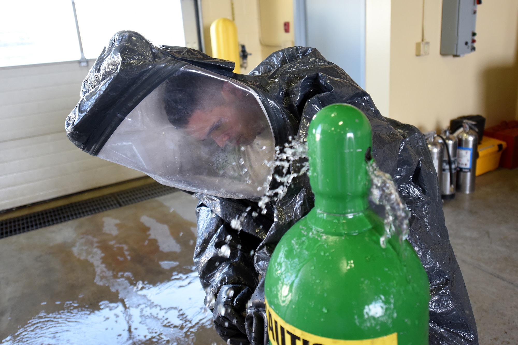 Senior Airman Hector Guemarezcolon, 341st Civil Engineer Squadron firefighter, practices stopping a leaking chlorine cylinder while wearing a level A hazardous materials protective suit April 22, 2015, at Malmstrom Air Force Base, Mont. The Malmstrom Fire Emergency Services Flight provides an all-hazards emergency response capability, along with command and control for the base. (U.S. Air Force photo/Chris Willis)