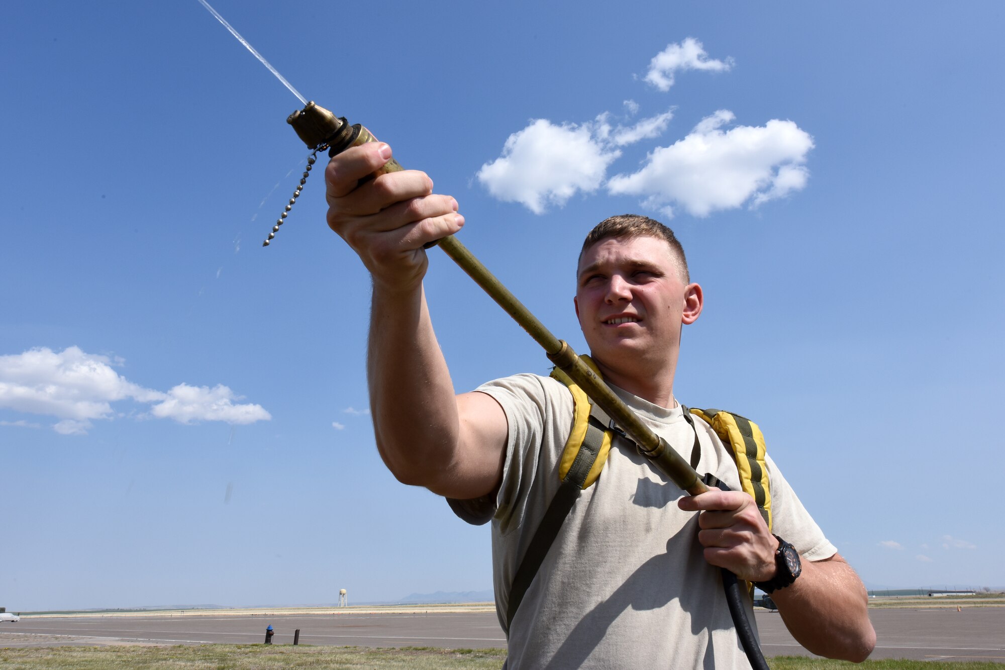 Senior Airman James Weaver, 341st Civil Engineer Squadron fire protection driver, checks a  backpack hand pump used to fight wildland fires April 22, 2015, at Malmstrom Air Force Base, Mont. Malmstrom firefighters also respond to wildland fires alongside local fire departments, following Mutual Aid requests. (U.S.  Air Force photo/Chris Willis)