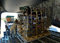 U.S. Air Force Senior Airman Tavin Alford, 436th Aerial Port Squadron air transportation journeyman, loads a pallet of equipment and supplies for the Fairfax County Urban Search and Rescue Team onto a C-17 Globemaster III, April 26, 2015, at Dover Air Force Base, Del. The 69-member search and rescue team is deploying to Nepal to assist with rescue operations after the country was struck by a 7.8-magnitude earthquake. (U.S. Air Force photo/Airman 1st Class William Johnson)
