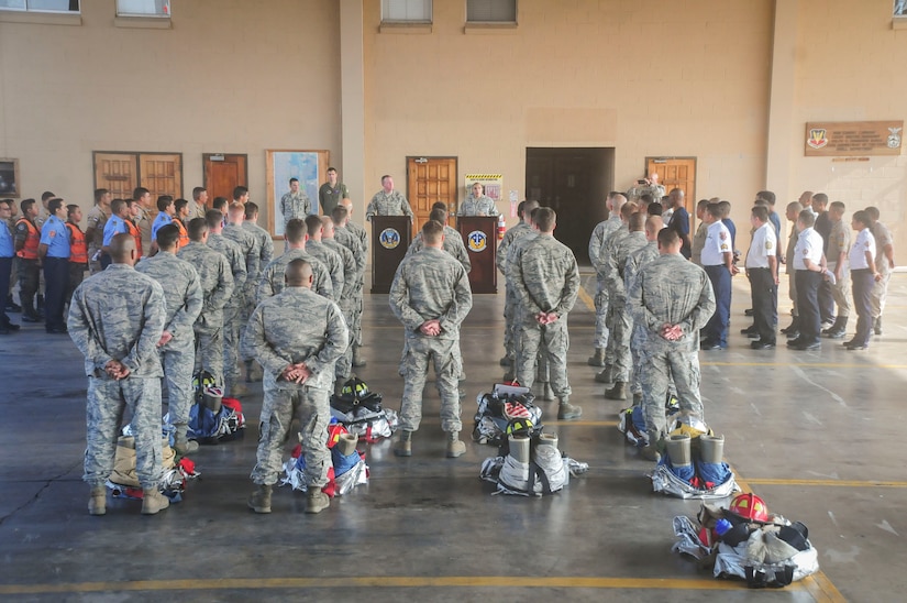U.S. Army Col. Kirk Dorr, Joint Task Force – Bravo commander (back center left), delivers remarks through a translator at the opening ceremony of the Central America Sharing Operations Knowledge and Experience exercise, April 20, 2015, at Soto Cano Air Base. CENTAM SMOKE brought U.S. firefighters together with counterparts from six of the seven CENTAM nations to train and enhance their ability to partner together on shared challenges. (U.S. Air Force photo by Capt. Christopher Love) 