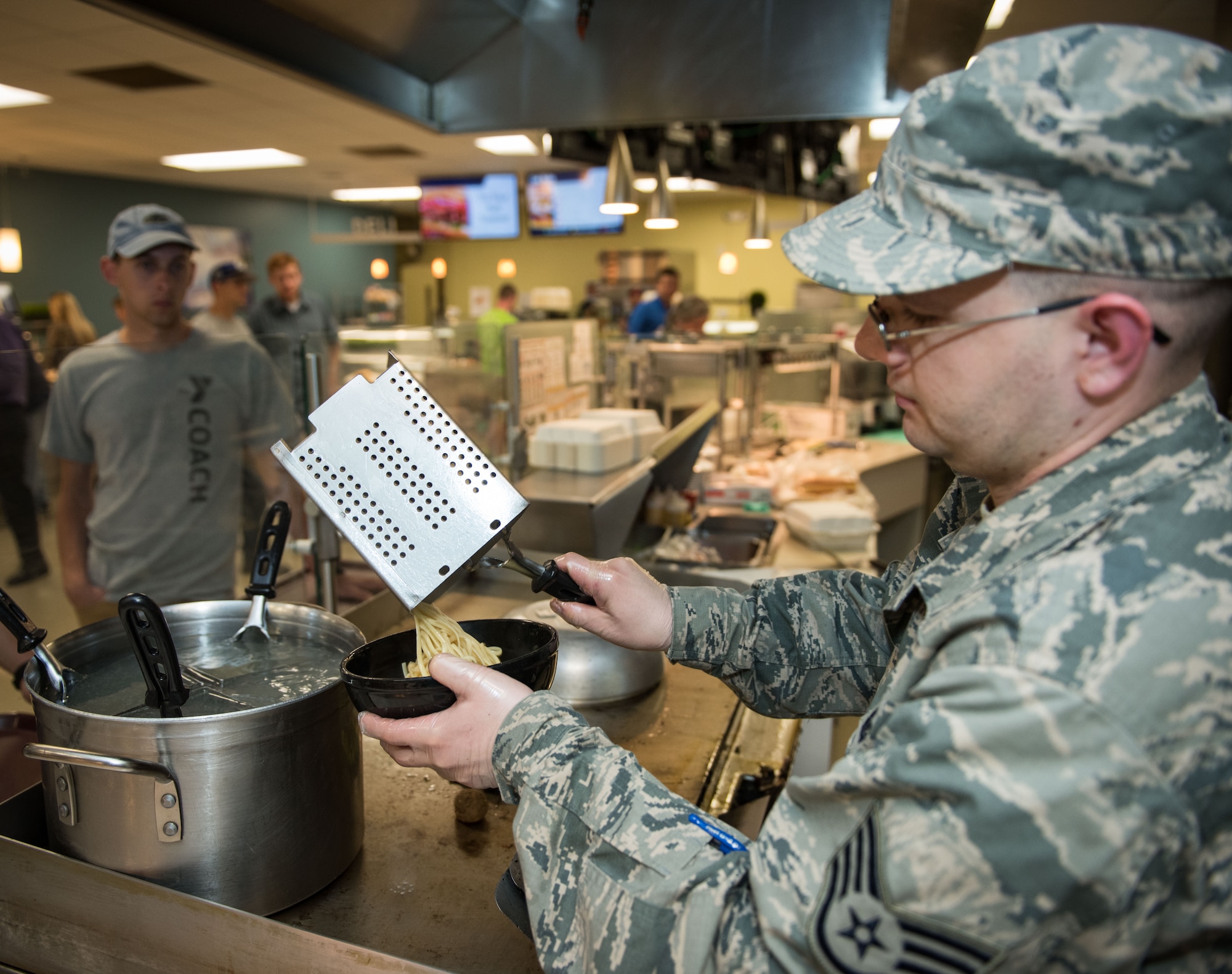 Staff Sgt. Nicholas Patton, 446th Force Support Squadron services craftsman, serves pasta during lunch at the Contrails Dining Facility on Beale Air Force Base, April 23. In addition to his food service training Patton is trained in lodging, fitness, recreation and mortuary affairs. (U.S. Air Force photo by Staff Sgt. Brenda Davis)