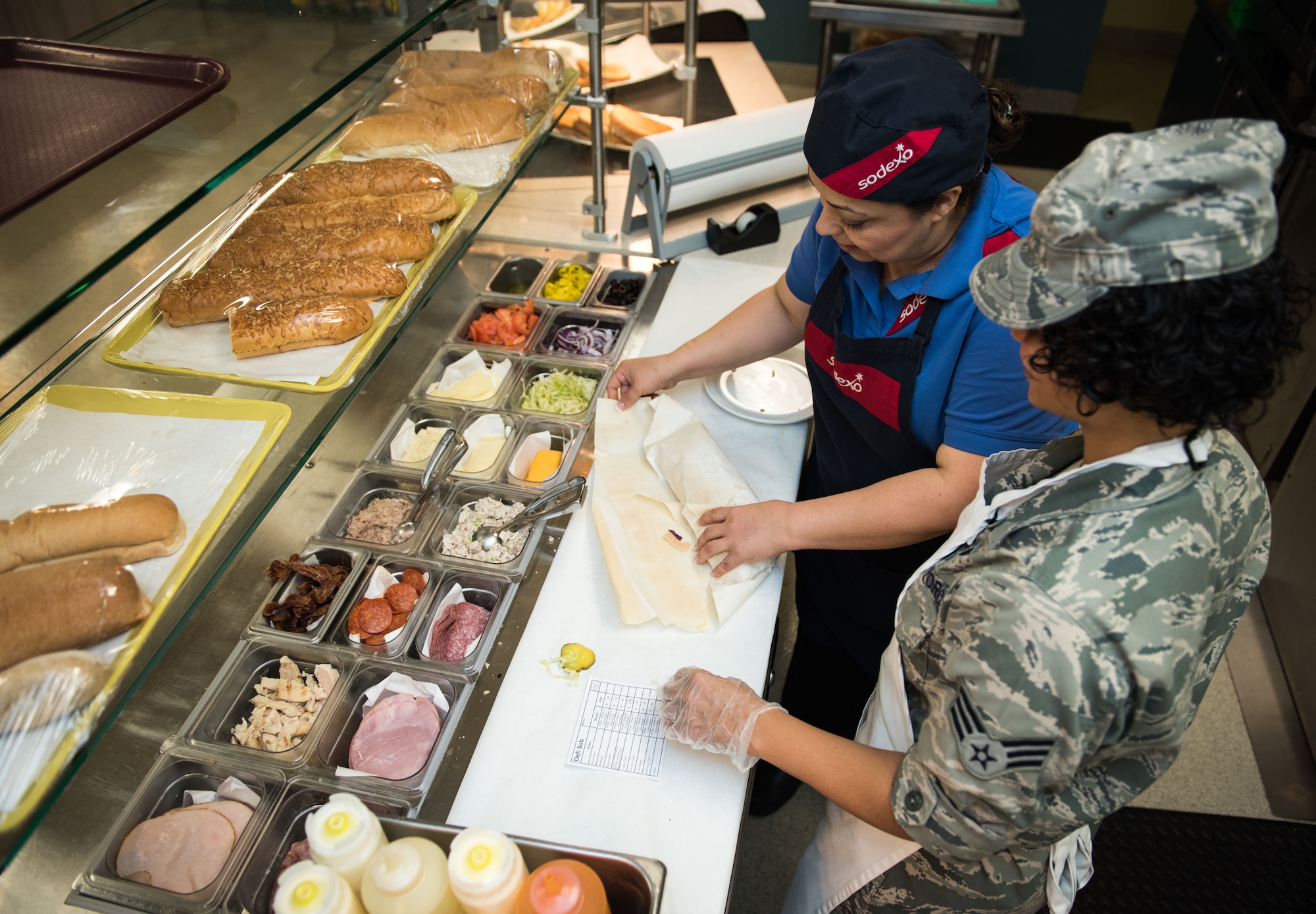 Senior Airman Leatha Brown, 446th Force Support Squadron services specialist, learns how to wrap a sandwich at the Contrails Dining Facility on Beale Air Force Base, April 23.  The Reservists from Joint Base Lewis-McChord were at Beale for their annual training in various duties including food service, fitness, recreation and mortuary affairs. (U.S. Air Force photo by Staff Sgt. Brenda Davis)