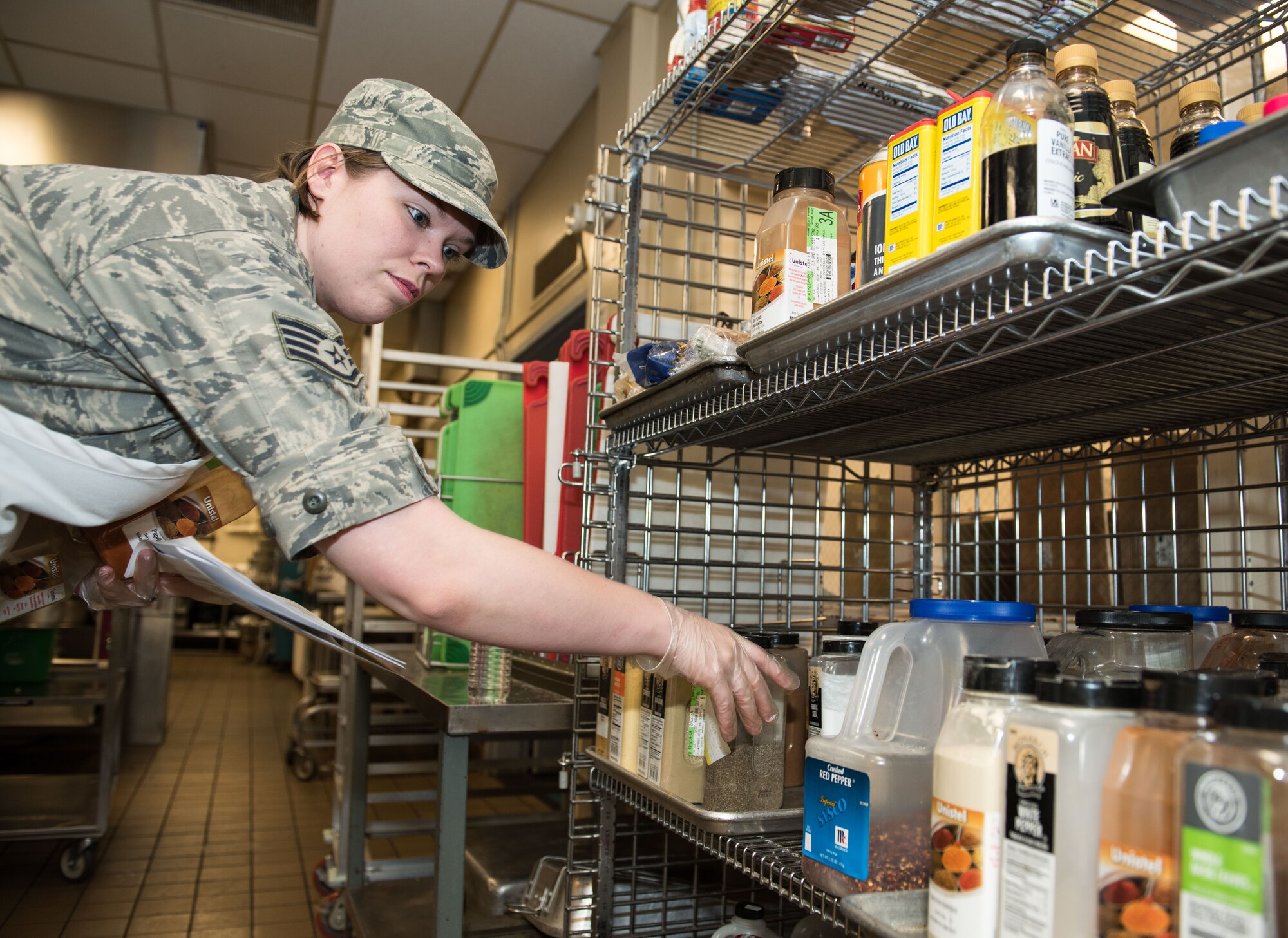 Staff Sgt. Bethany Hiser, 446th Force Support Squadron services specialist, picks out ingredients for a spice rub at the Contrails Dining Facility on Beale Air Force Base, April 23.  Hiser’s day began at 4 a.m. preparing ingredients for meals later in the today. (U.S. Air Force photo by Staff Sgt. Brenda Davis)