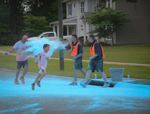 Participants pass through a paint station during the Paint Run 5K Fun Run, April 25, 2015 at Joint Base Charleston – Weapons Station, S.C. This free event was open to everyone and was co-hosted by Joint Base Charleston Sexual Assault Prevention and Response Program. April is sexual assault awareness month. This year’s theme is, “Eliminate Sexual Assault: Know your part. Do your part.” The purpose of sexual assault awareness month is to raise awareness about sexual assault prevention and support sexual assault survivors. (U.S. Air Force photo/Staff Sgt. Ashley Hyatt)