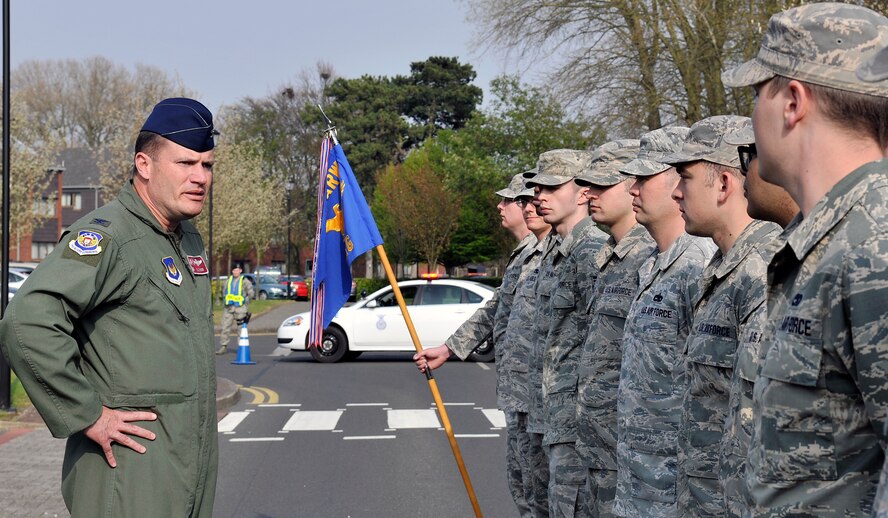 U.S. Air Force Col. Kenneth T. Bibb, Jr., 100th Air Refueling Wing commander, speaks to 100th Maintenance Group Airmen following the conclusion of the monthly retreat ceremony April 24, 2015, on RAF Mildenhall, England. Retreat is a ceremony symbolizing the end of the duty day as well as paying respect to the flags. (U.S. Air Force photo by Airman 1st Class Kyla Gifford/Released)