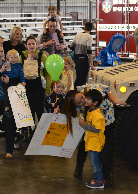 James, son of Master Sgt. Jason and Michelle Balolong, is welcomed home during Kids Deploy 2015 event at Ellsworth Air Force Base, S.D., April 18, 2015. The event is in support of the Month of the Military Child which provides an inclusive educational opportunity for all military children affected by mobility and family separation. (U.S. Air Force photo by Airman 1st Class Rebecca Imwalle/Released)
