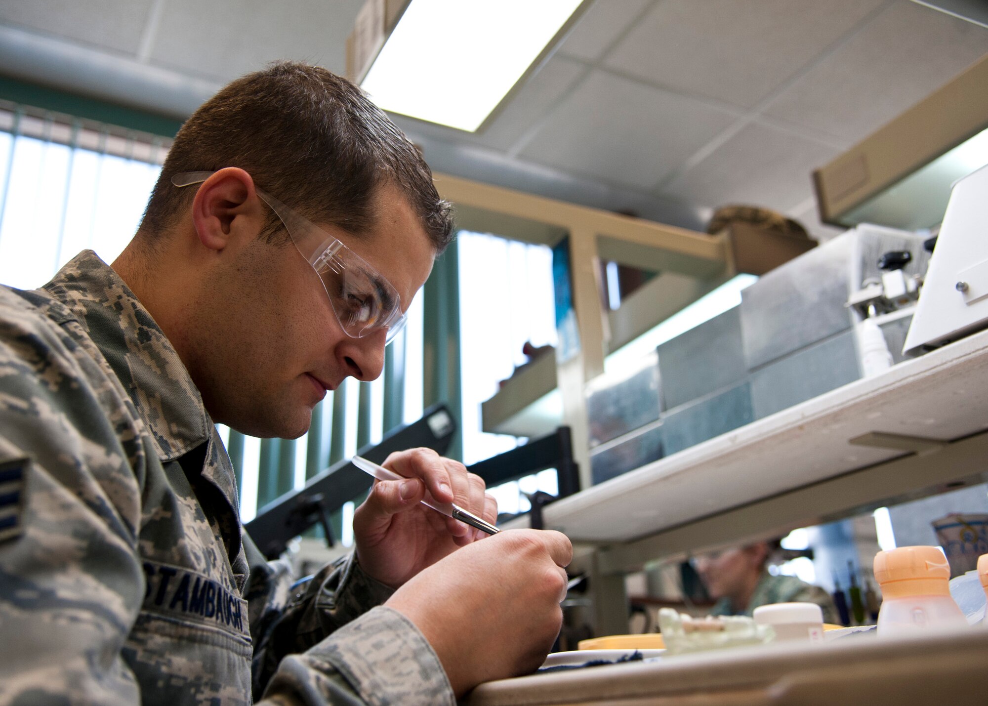 PETERSON AIR FORCE BASE, Colo. – Senior Airman Jonathon Stambaugh, 21st Dental Squadron dental lab technician, works on creating porcelain teeth at the Area Dental Lab, April 8, 2015. The ADL is one of three Department of Defense labs that provide fixed dental works along with removable dental works and services Department of Defense bases around the world. The other two ADLs are in Ramstein AB, Germany, and Kadena AB, Japan. (U.S. Air Force photo by Senior Airman Tiffany DeNault)